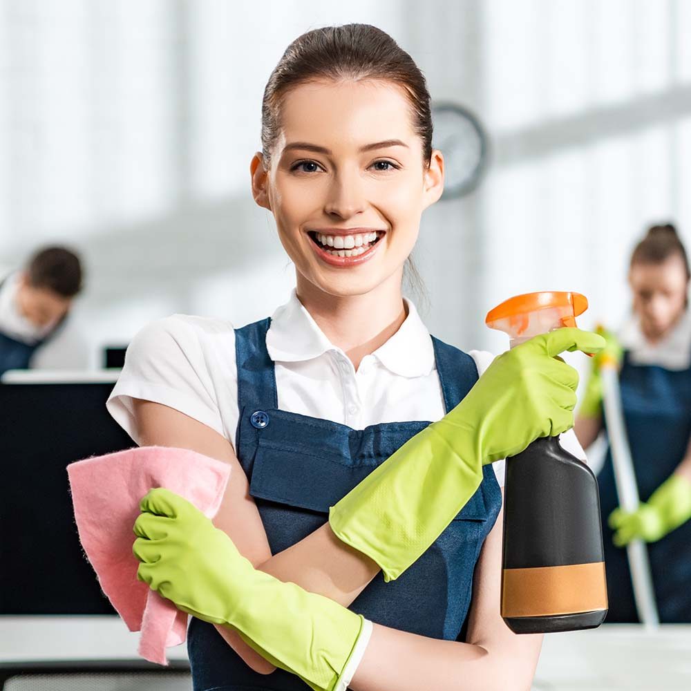 happy-cleaner-with-spray-and-rag-smiling-at-camera3-QCHMFLG